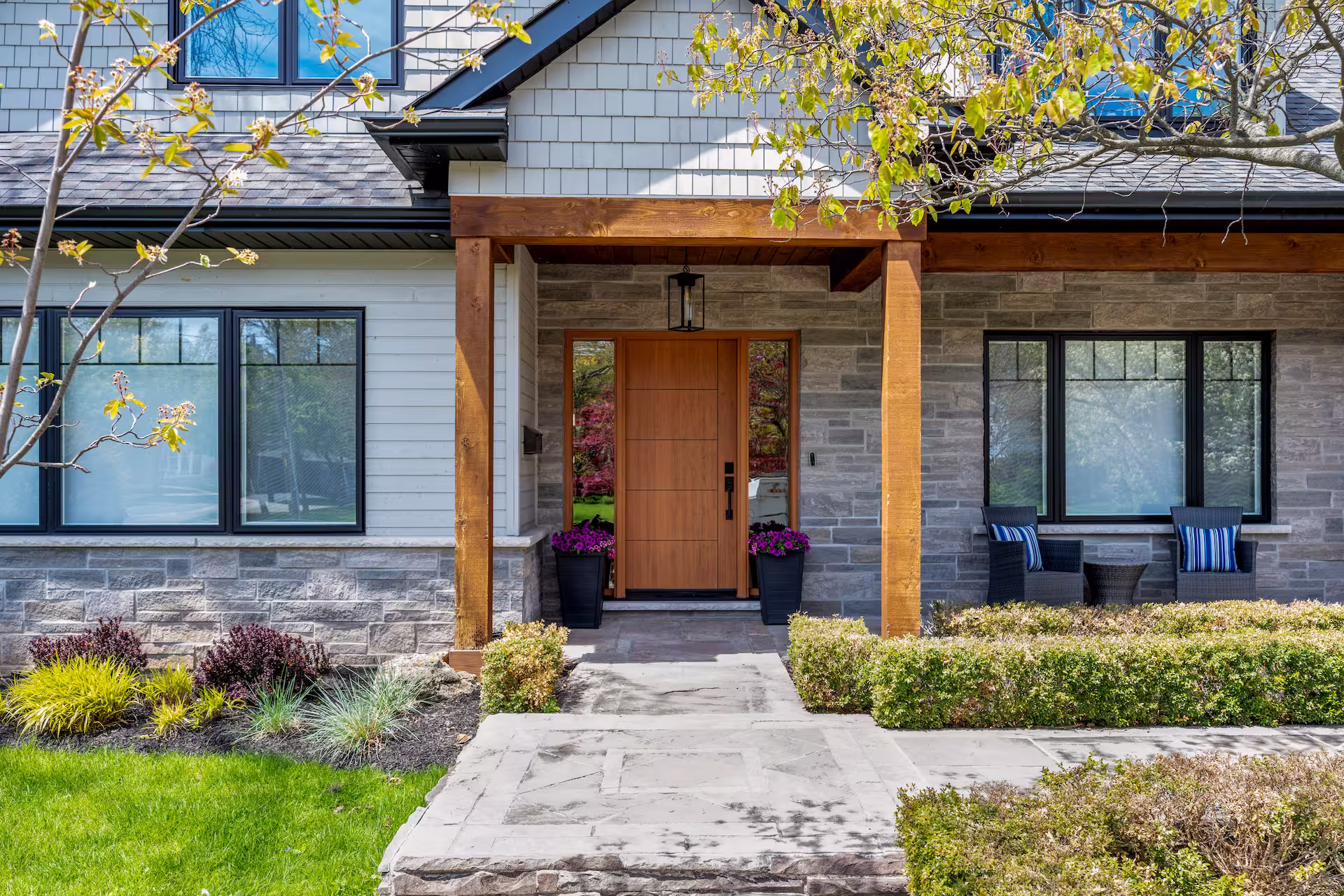 Finished front entry with timber post-and-beam porch and stone detailing, Burlington full home transformation