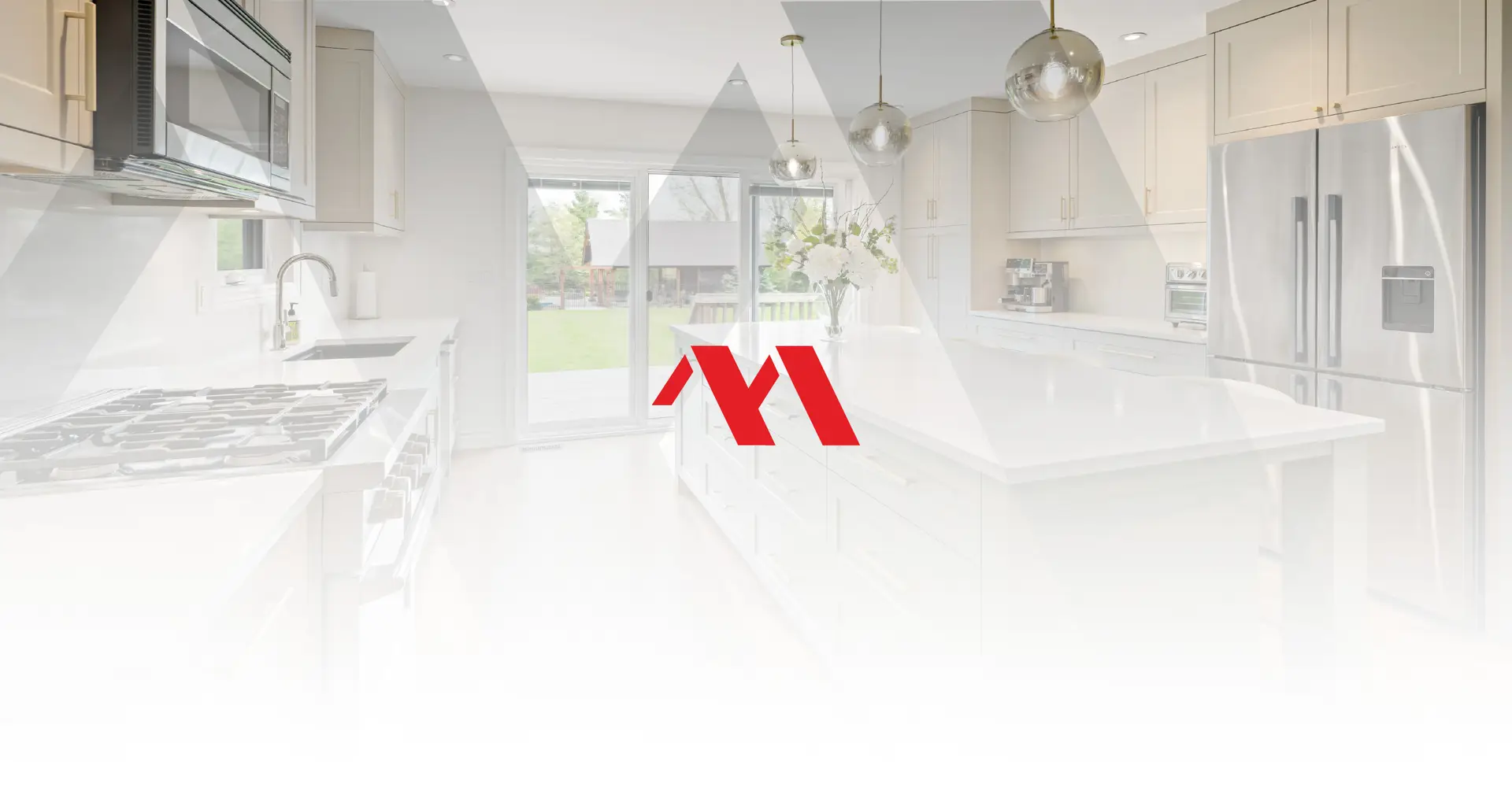 Renovated white kitchen with a quartz island, pendant lights and stainless appliances, with the Marcon Construction mark overlaid