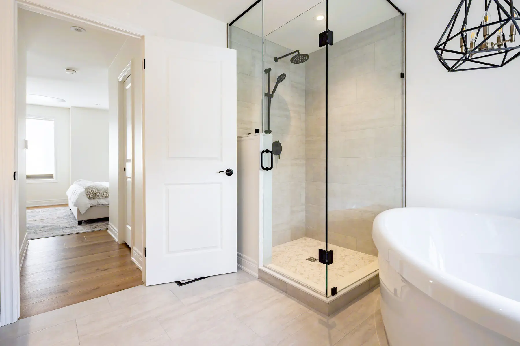 Glass shower with matte black fixtures and a freestanding tub, Burlington second-storey and main floor renovation